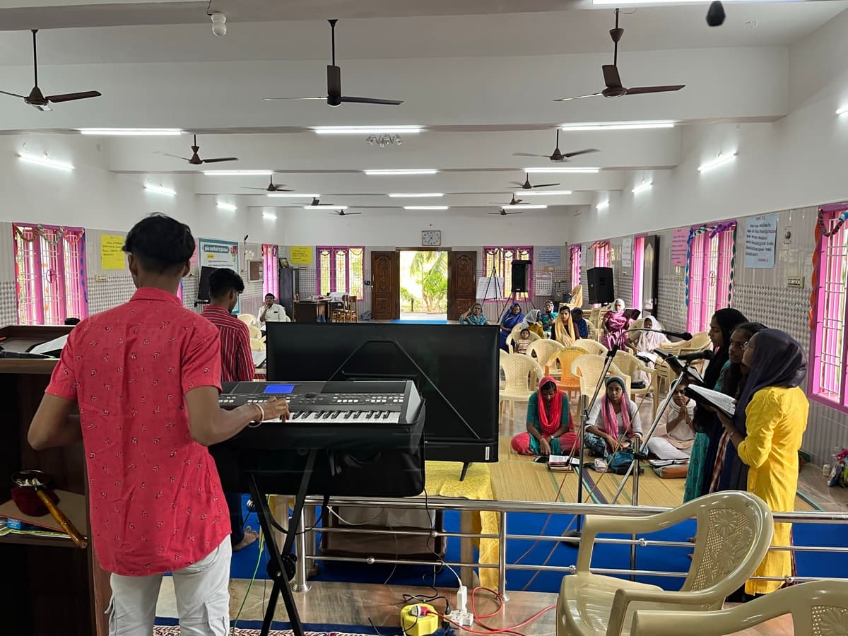 Congregation during Sunday worship service with keyboard player at Good Samaritan Mission