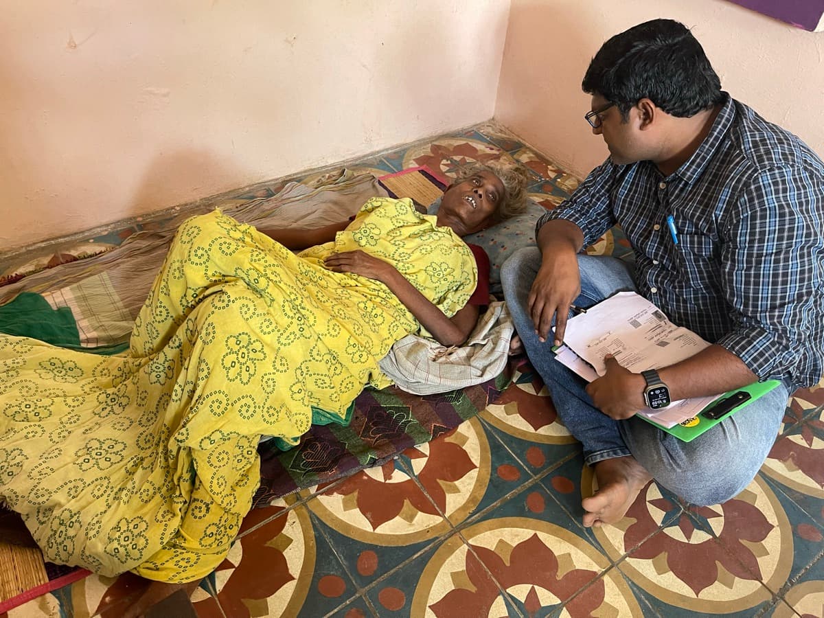Home visit providing care and support to a bedridden elderly person